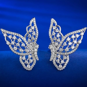Close-up of hollow butterfly stud earrings with sparkling pave-set stones