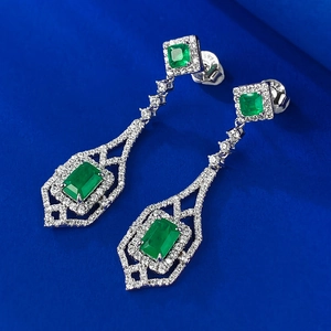 Detailed macro view of S925 sterling silver stamp and emerald cut green stone earring