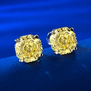 Macro shot of 925 silver stud earrings with octagon-cut yellow carbon diamonds