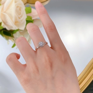 Macro shot of rose gold flower cluster ring with pavé diamonds on a model's hand