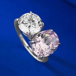Macro shot of Toi et Moi ring with oval pink carbon diamond and round white stone detail