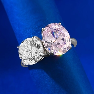 Elegant Toi et Moi ring featuring a pink oval gem and white round stone in silver setting