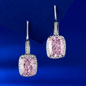 Macro shot of S925 silver pink cushion-cut gemstone earrings with white halo setting