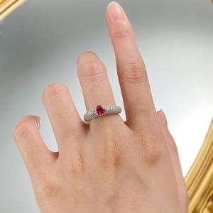 Detailed view of heart-shaped pigeon blood ruby ring with pave diamonds on 925 silver band