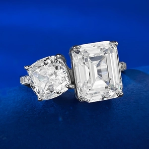 Macro detail of Toi et Moi S925 silver ring featuring emerald and cushion cut lab diamonds