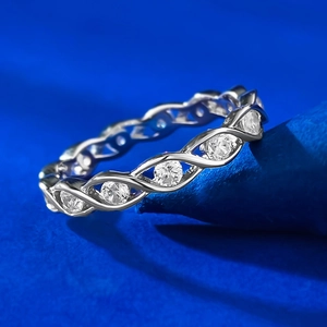 Macro detail of S925 silver pavé ring with intertwined bands and sparkling cubic zirconia