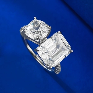 Detail of Toi et Moi S925 silver ring with emerald and cushion cut simulated diamonds