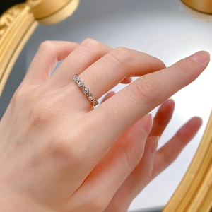 S925 sterling silver ring with twisted band and clear zircons on mirror reflection