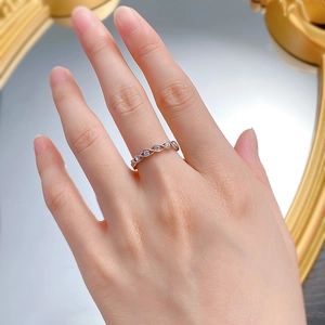Close-up of S925 silver twisted ring with shimmering micro-pave crystals on model hand