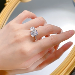 Close-up of S925 silver Toi et Moi ring featuring emerald-cut and square diamonds