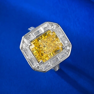 Macro shot of 4 carat radiant cut yellow gemstone ring on a blue velvet backdrop