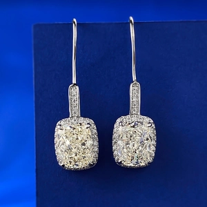 Macro detail of S925 silver halo earrings with cushion cut yellow stones and micro pavé