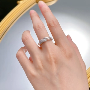 Detail of S925 silver flower ring with brushed texture and pavé set cubic zirconia