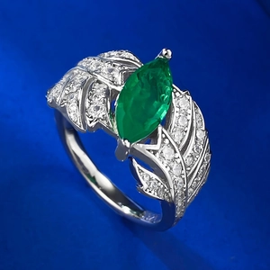 Macro shot of marquise-cut emerald ring with s925 silver leaf side stones