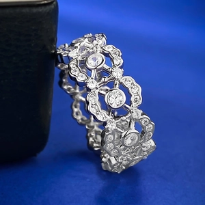 Macro shot of 925 sterling silver hollow lace ring with zircon inlay and retro pattern