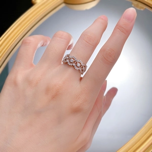 Vintage 925 silver hollow floral ring with zircon stones shown on finger against a mirror