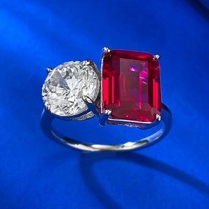 Macro shot of 925 silver ring featuring a round white diamond and emerald-cut ruby
