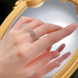 Close-up of 925 silver hollow floral ring with zircons reflected in a vintage mirror