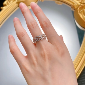 Close-up of 925 silver hollow lace ring with zircon pavé worn on a finger