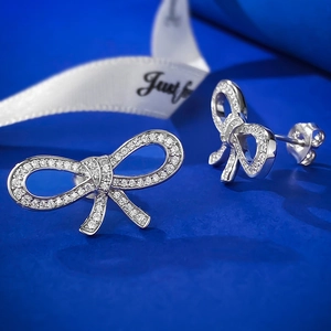 Detailed view of S925 sterling silver bow earrings with pavé set cubic zirconia stones