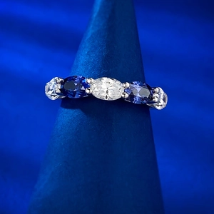 Vue macro d'une bague en argent sertie de cinq pierres ovales blanches et tanzanites