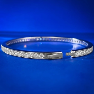 Macro shot of silver sterling tennis bracelet with round cut diamonds and clasp detail