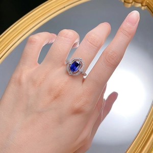 S925 silver ring featuring an oval blue sapphire with double halo of sparkling diamonds
