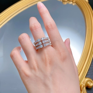 Detailed view of luxury silver-tone triple-row zircon wide band ring on model hand