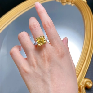 Macro view of 925 silver ring featuring a large yellow square-cut diamond on hand