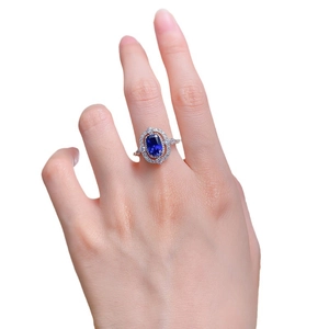 Elegant S925 silver ring featuring a large oval blue sapphire with double halo of diamonds