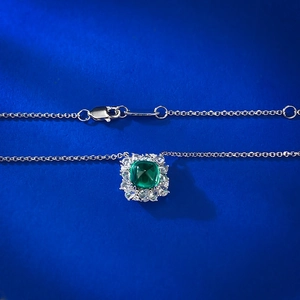 Detailed macro view of green square-cut gemstone pendant with silver lobster clasp chain