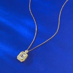 Detail of 925 silver emerald cut perfume bottle pendant with halo pave setting