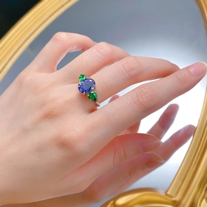 Detailed macro of S925 silver ring with oval tanzanite blue and green pear stones