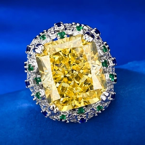Macro shot of 15ct radiant cut yellow gemstone with ornate engraved hollow metal shank