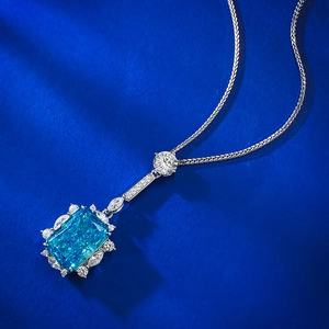 Macro view of Radiant-cut blue gemstone pendant with S925 silver marquise diamond halo
