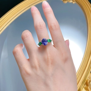Detailed view of S925 silver ring with oval tanzanite blue and green pear stones