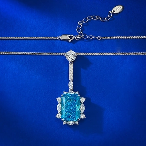 Macro shot of S925 sterling silver stamp and radiant cut blue gemstone pendant