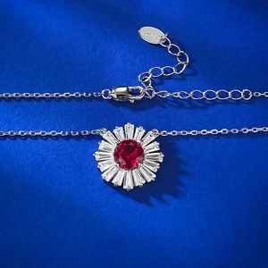 Macro shot of S925 silver pendant with red ruby-like stone and clear zircon accents