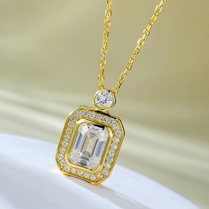 Detailed view of emerald-cut crystal pendant with micro-pave diamonds on a gold chain