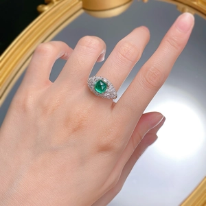 S925 silver ring featuring a 6.5mm emerald-cut green stone with halo setting on a model