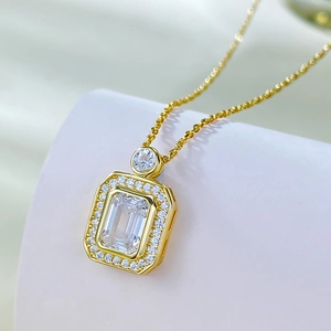 Macro shot of 925 silver perfume bottle pendant with emerald-cut crystal and gold plating