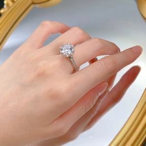 Macro shot of 3ct carbon diamond ring with crown six-prong setting and pavé silver band