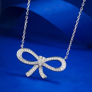 Classic 925 silver ribbon bow necklace featuring brilliant pavé setting on blue satin