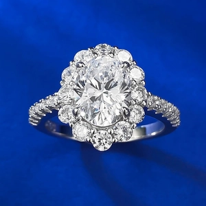 Elegant halo diamond ring featuring an oval-cut center stone and paved silver band