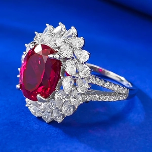 Elegant S925 silver ring with large oval ruby red gemstone and cluster zircon halo
