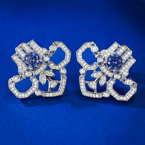 Detailed macro view of S925 sterling silver earrings with blue gemstones and fine diamonds
