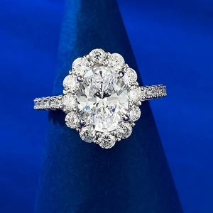 Elegant halo ring with oval-cut diamond on a silver band and micro-pave stones