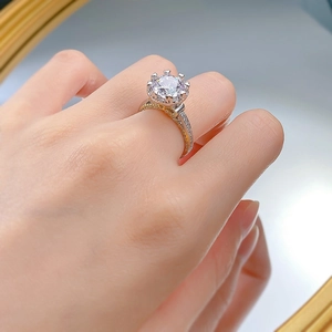 Macro shot of a 3-carat round brilliant cubic zirconia set in a gold crown six-prong ring