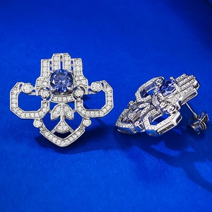 Detail of Art Deco S925 silver stud earrings with a round blue sapphire stone and zircons