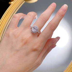Luxurious silver ring with large oval diamond main stone and double halo of pave diamonds